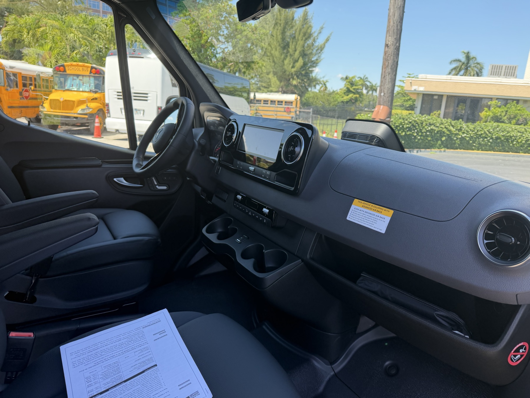 Driver cabin and dashboard inside the black Mercedes-Benz Sprinter van