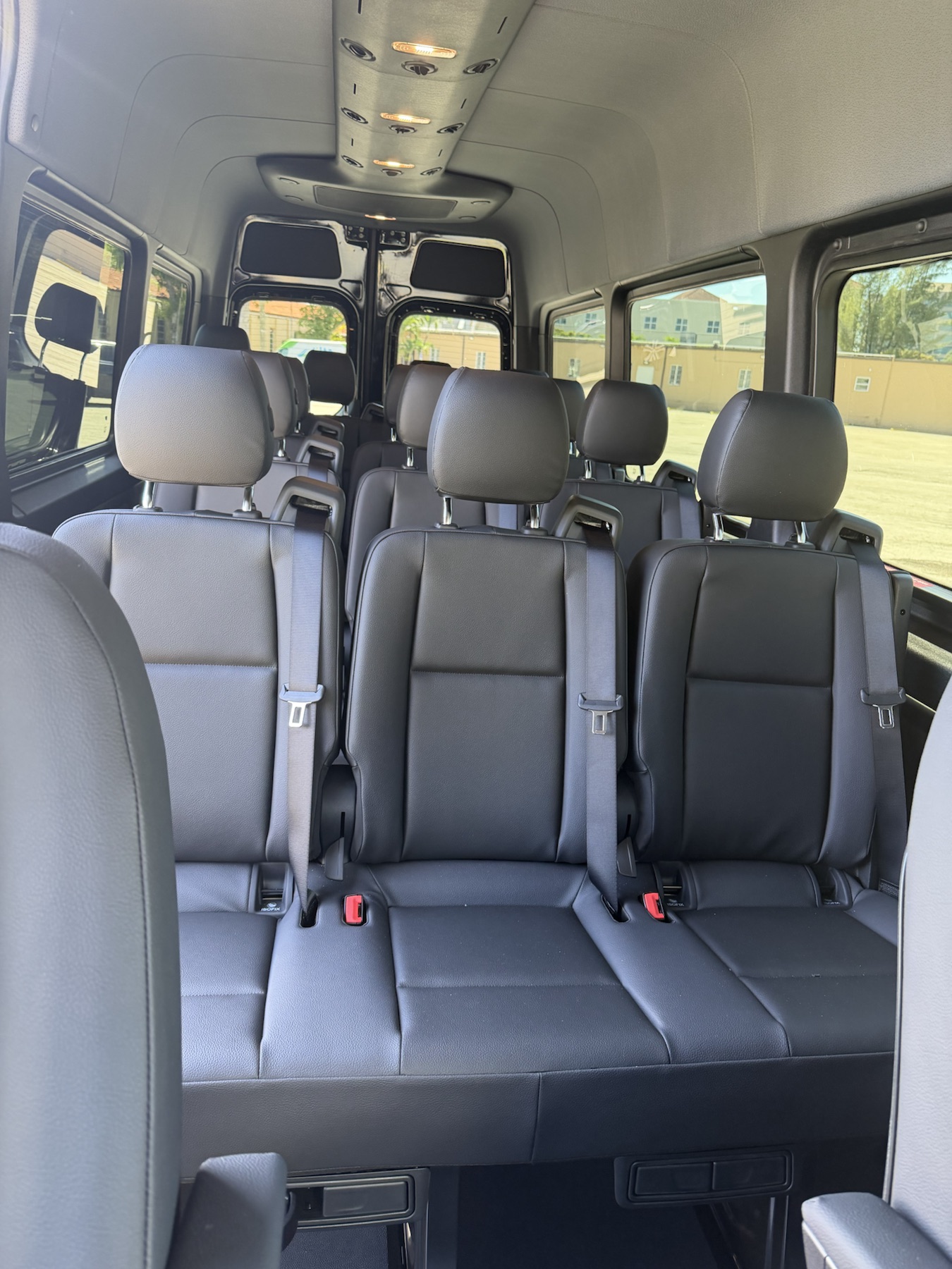 Passenger seating inside the black Mercedes-Benz Sprinter van