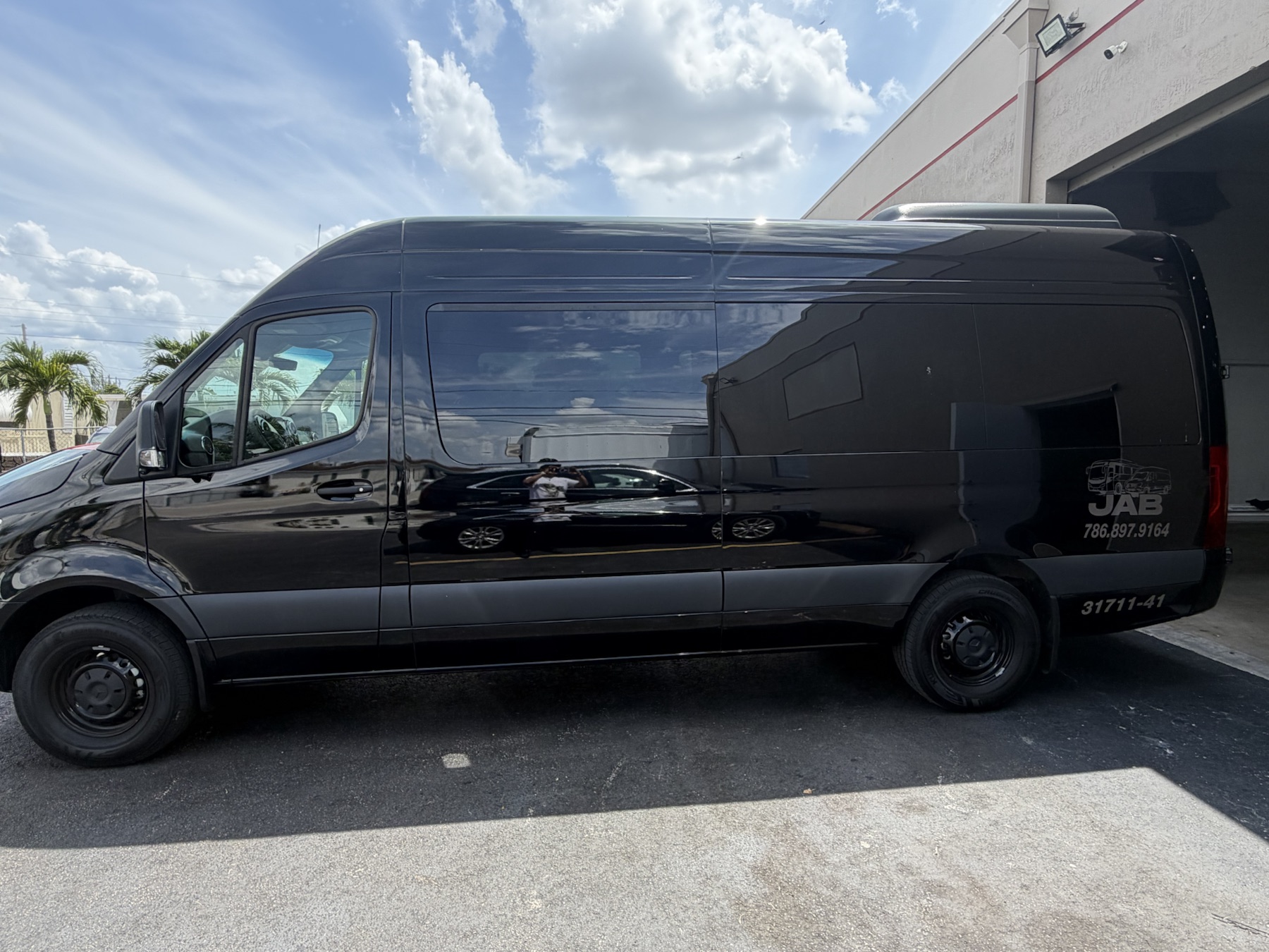 Side exterior profile of the black Mercedes-Benz Sprinter van